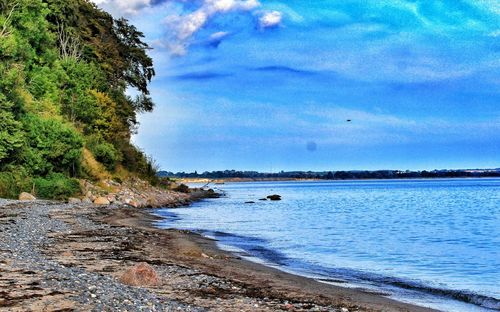 Scenic view of sea against cloudy sky