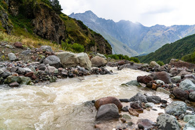 Scenic view of river flowing through rocks