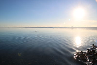 Scenic view of lake against sky at sunset