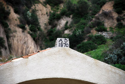 Text on rock by road