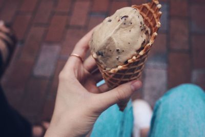 Close-up of hand holding ice cream cone