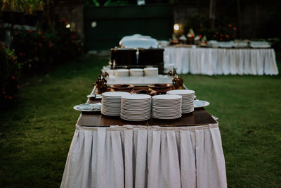 Stack of chairs on table at field