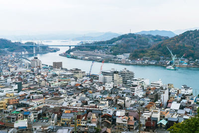 High angle view of harbor and buildings in city