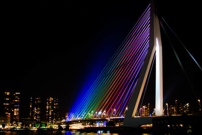 Low angle view of illuminated city against sky at night