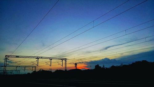 Low angle view of electricity pylon against sky