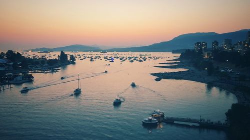 High angle view of boats in sea at sunset