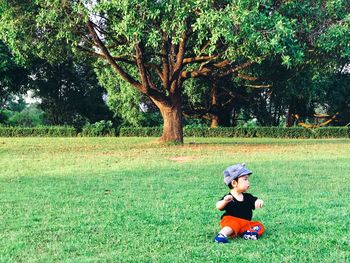 Boy sitting on field