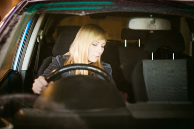 Close-up of woman sitting in car