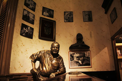 Statue of woman sitting in building