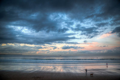 Scenic view of beach against sky during sunset