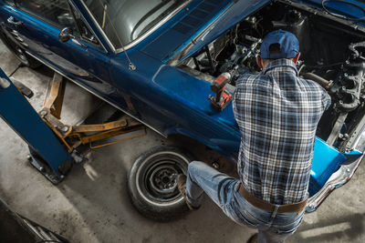 Rear view of man standing in car