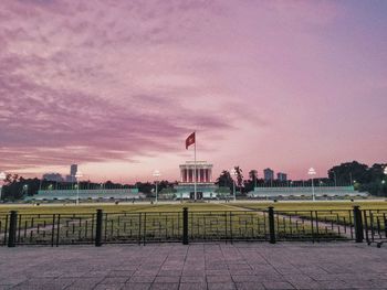 Buildings against cloudy sky at sunset