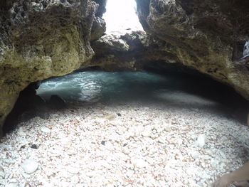Close-up of pebbles at beach against sky