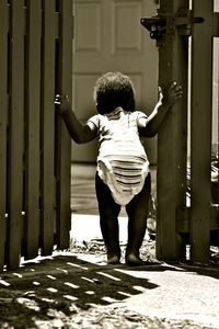 Rear view of girl standing on doorway