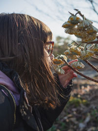 Rear view of woman standing against plants