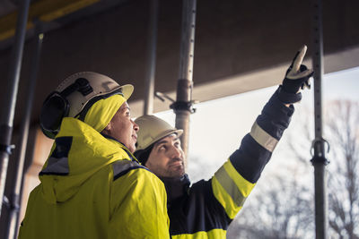 Engineers talking at building site