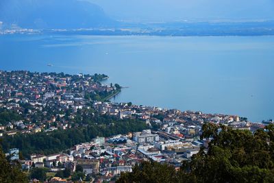 High angle view of townscape by leman lake against sky