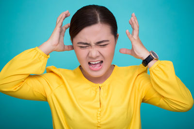 Young woman against blue background