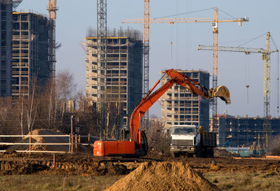 Construction site in city against sky