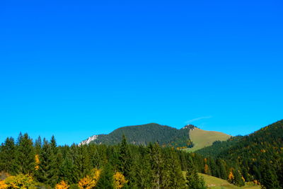 Scenic view of mountains against clear blue sky