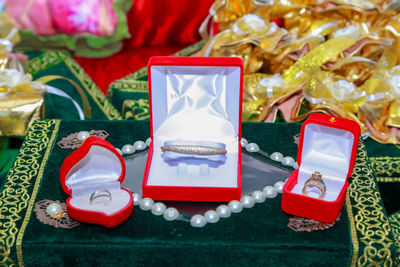 High angle view of wedding rings in boxes on book