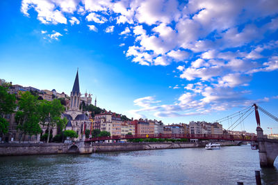 Bridge over river with buildings in background