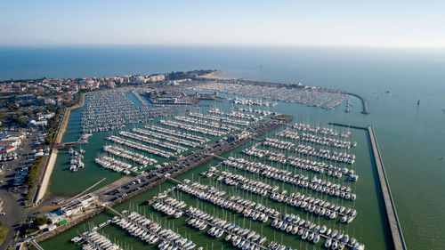 High angle view of buildings by sea against sky