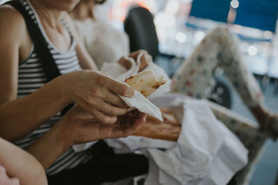 Midsection of woman eating food