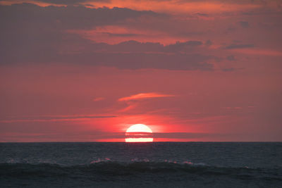 Scenic view of sea against orange sky
