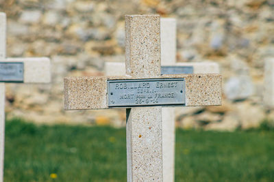 Close-up of information sign on grass