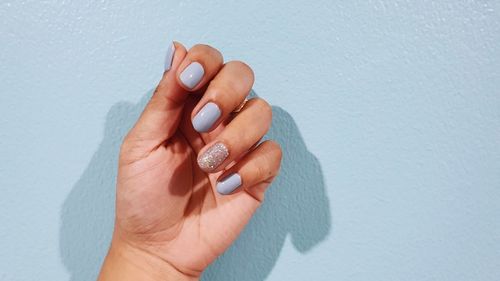 Close-up of woman hand on wall