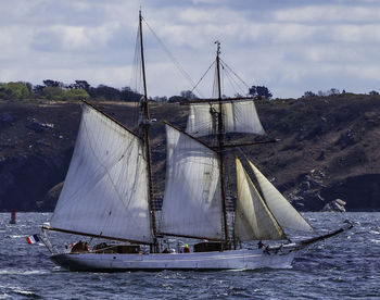 Sailboat sailing on sea against sky