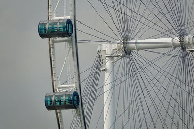 Low angle view of electricity pylon against sky