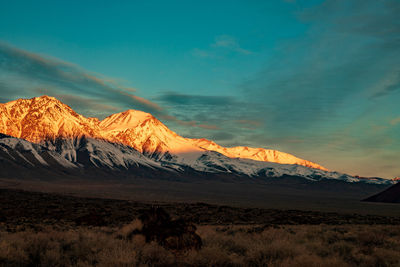 Scenic view of snowcapped mountains against sky during sunset