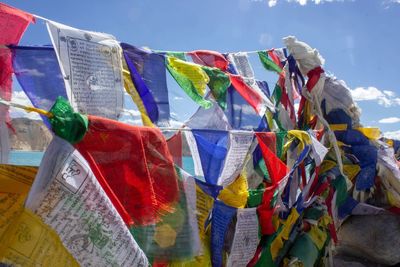 Low angle view of flags hanging against sky