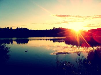 Scenic view of sunset over lake