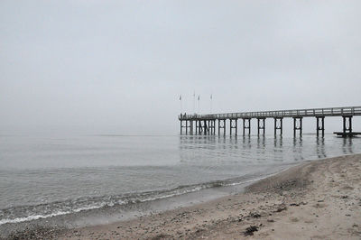 Pier on sea against clear sky