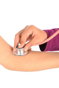 Close-up of woman holding hands over white background