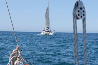 Sailboat on sea against clear sky