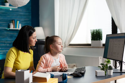 Mother assisting daughter at home