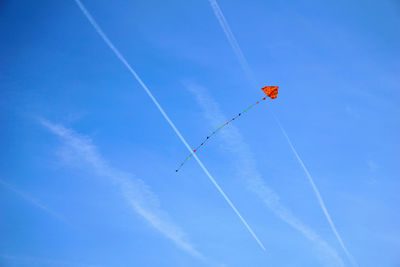 Low angle view of kite flying against blue sky