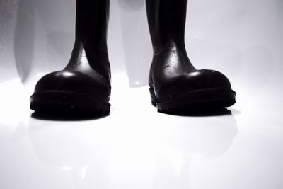 Low section of woman standing on tiled floor