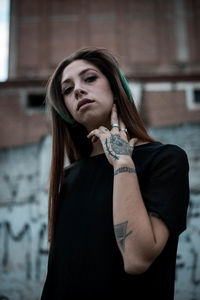 Portrait of beautiful young woman standing outdoors