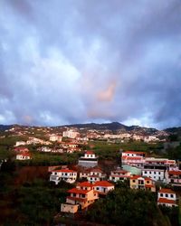 Houses in town against sky