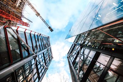 Low angle view of buildings against cloudy sky