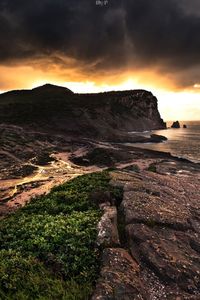 Scenic view of land against sky during sunset