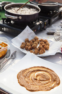 High angle view of food ingredients by stove on table