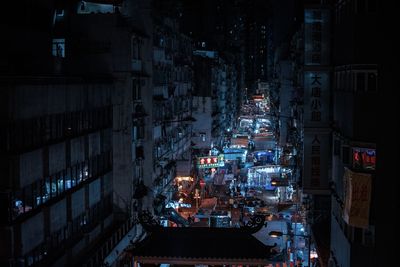 High angle view of illuminated cyberpunk  buildings in city at night 