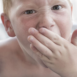 Close-up portrait of boy yawning