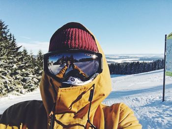 Person wearing ski goggles on snow